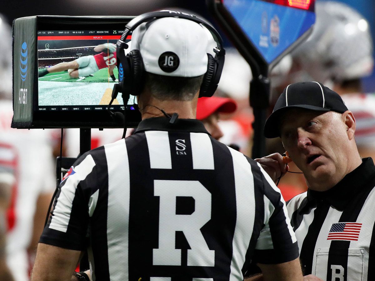 A catch by Brock Bowers is reviewed by officials