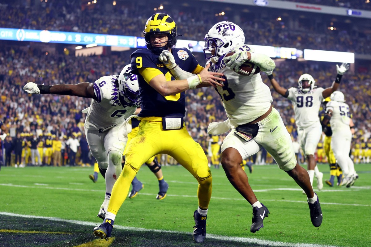 TCU Horned Frogs linebacker Dee Winters (13) scores on a pick-six against Michigan Wolverines quarterback J.J. McCarthy (9) in the third quarter of the 2022 Fiesta Bowl. (Mark J. Rebilas-USA TODAY Sports)