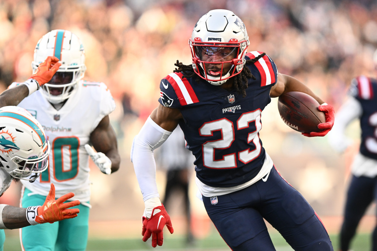 Jan 1, 2023; Foxborough, Massachusetts, USA; New England Patriots safety Kyle Dugger (23) runs for a touchdown after intercepting the ball during the second half of agame against the Miami Dolphins at Gillette Stadium.