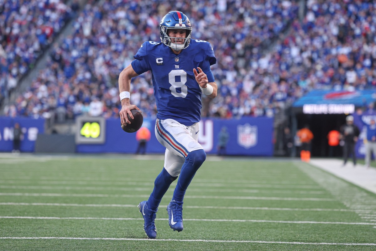 Jan 1, 2023; East Rutherford, New Jersey, USA; New York Giants quarterback Daniel Jones (8) scores a rushing touchdown during the second half against the Indianapolis Colts at MetLife Stadium.