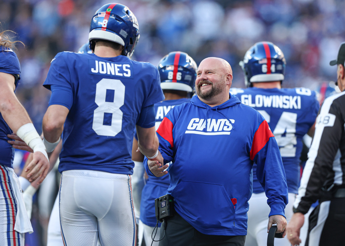 Daniel Jones and Brian Daboll shake hands on the sideline during a win over the Colts