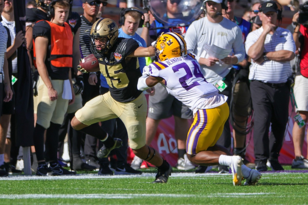 Purdue Boilermakers running back Devin Mockobee (45) is driven out of bounds by LSU Tigers cornerback Jarrick Bernard-Converse (24) during the second quarter at Camping World Stadium.