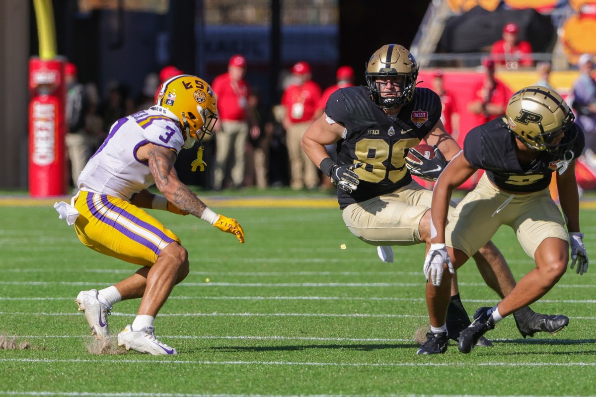 Purdue Boilermakers tight end Paul Piferi (89) runs the ball against LSU Tigers safety Greg Brooks Jr. (3) during the second quarter at Camping World Stadium.