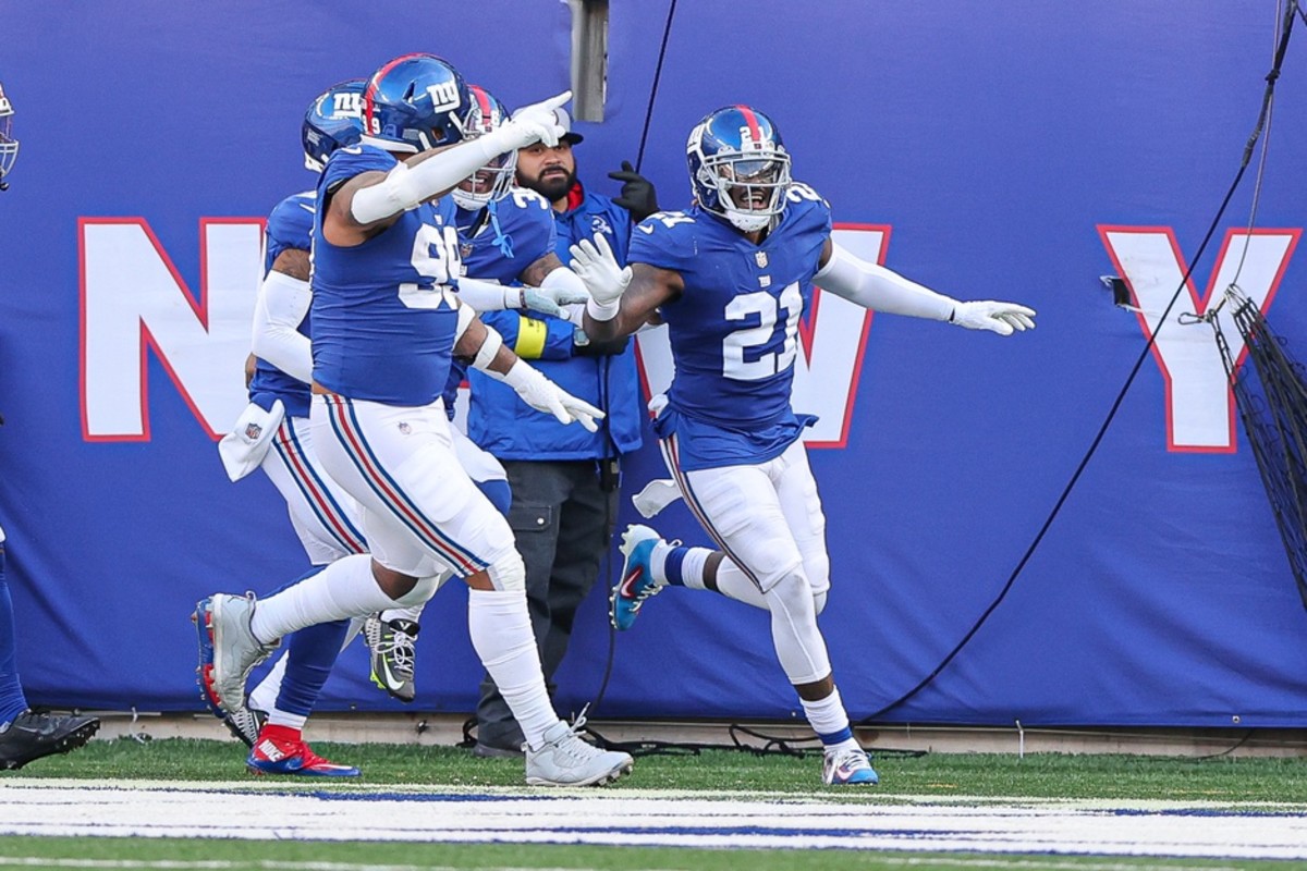 Jan 1, 2023; East Rutherford, New Jersey, USA; New York Giants safety Landon Collins (21) celebrates his interception for a touchdown with teammates during the first half against the Indianapolis Colts at MetLife Stadium.