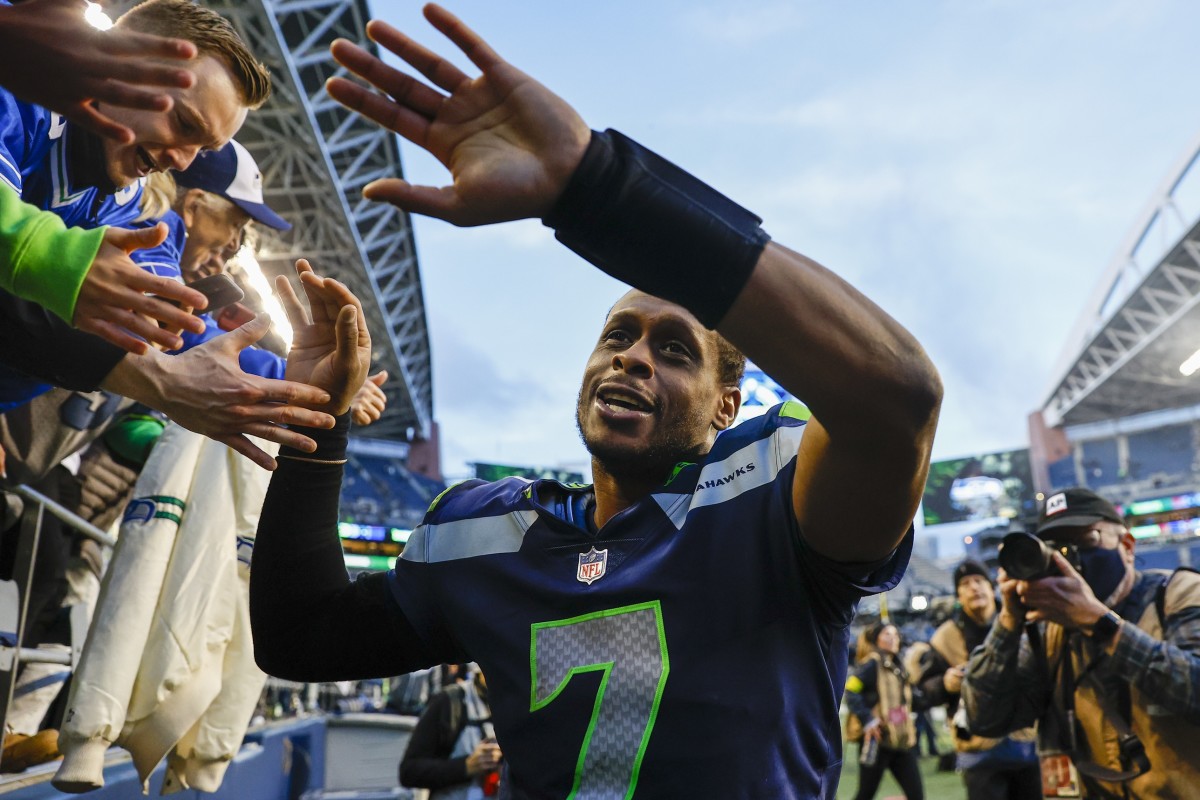 Seahawks quarterback Geno Smith celebrates with fans after beating the Jets in Week 17.