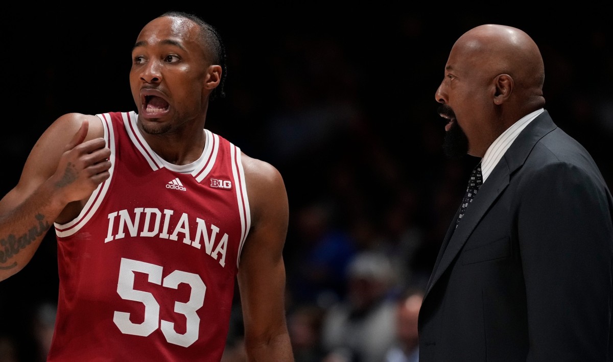 Indiana guard Tamar Bates and coach Mike Woodson chat on the sidelines. (USA TODAY Sports)
