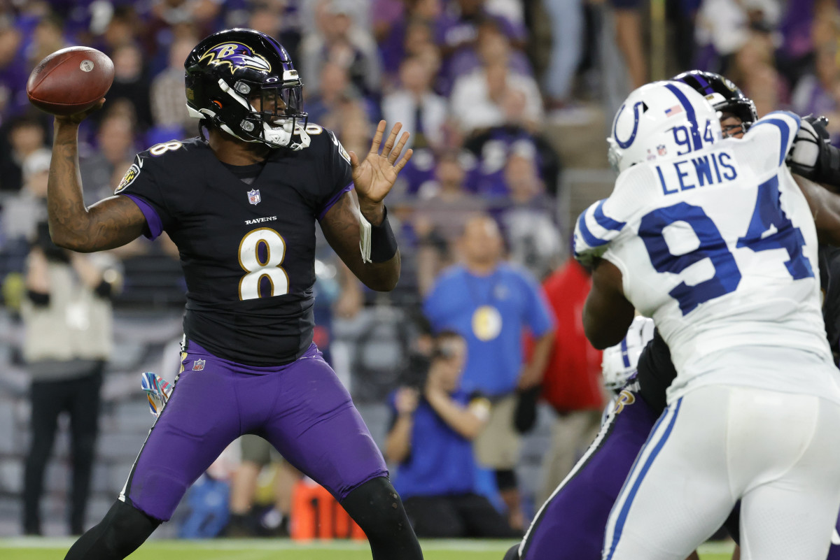 Oct 11, 2021; Baltimore, Maryland, USA; Baltimore Ravens quarterback Lamar Jackson (8) passes the ball as Indianapolis Colts defensive end Tyquan Lewis (94) defends during the third quarter at M&T Bank Stadium.