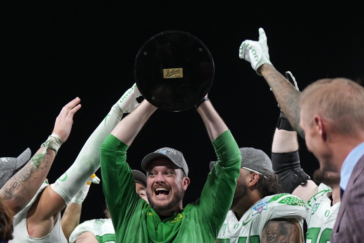 Oregon Ducks head coach Dan Lanning celebrates with the championship trophy after the 2022 Holiday Bowl against the North Carolina Tar Heels at Petco Park.