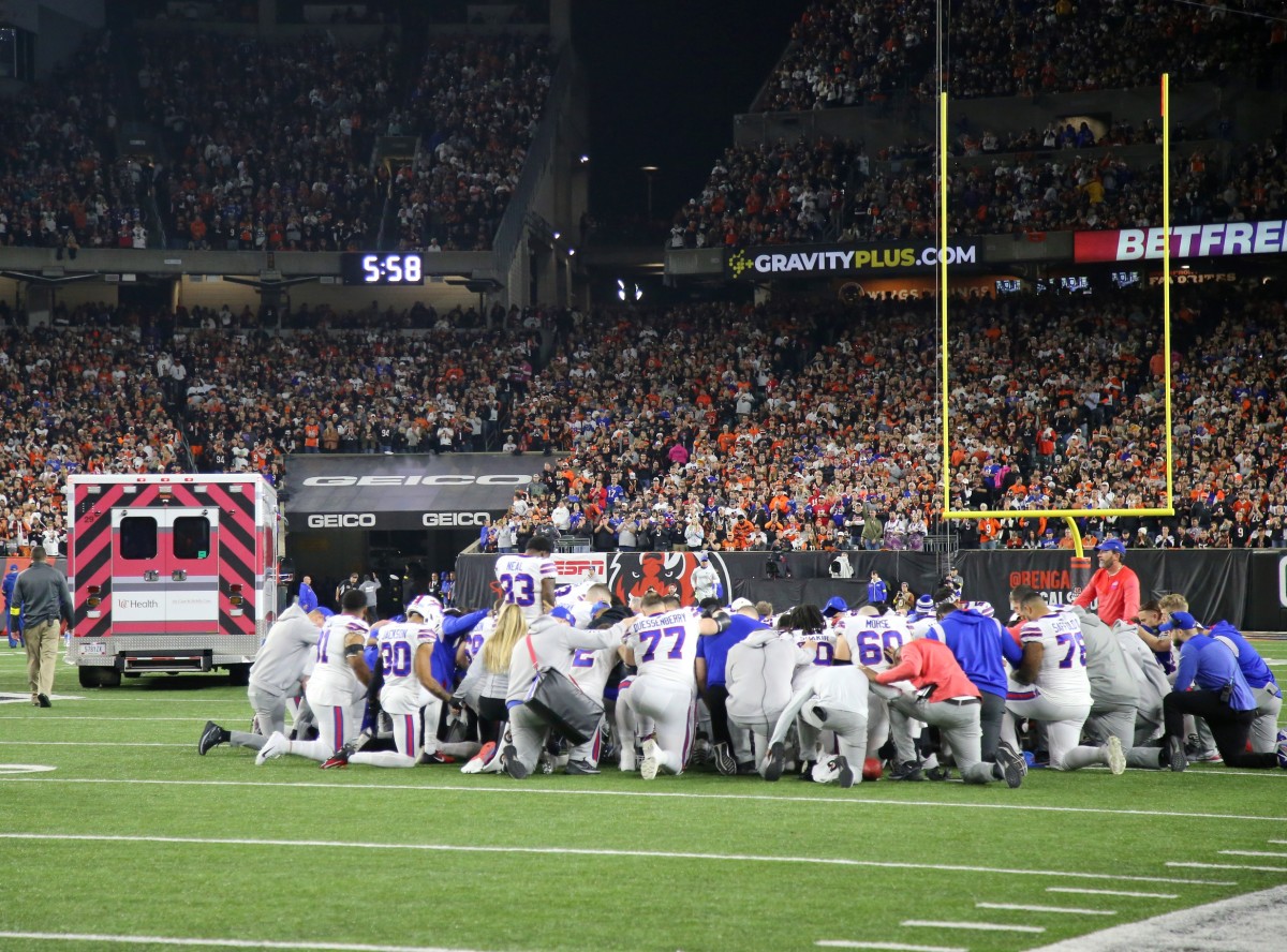 Bills players gather to pray and share their feelings shortly after Damar Hamlin was taken away in an ambulance during Monday night's game in Cincinnati.