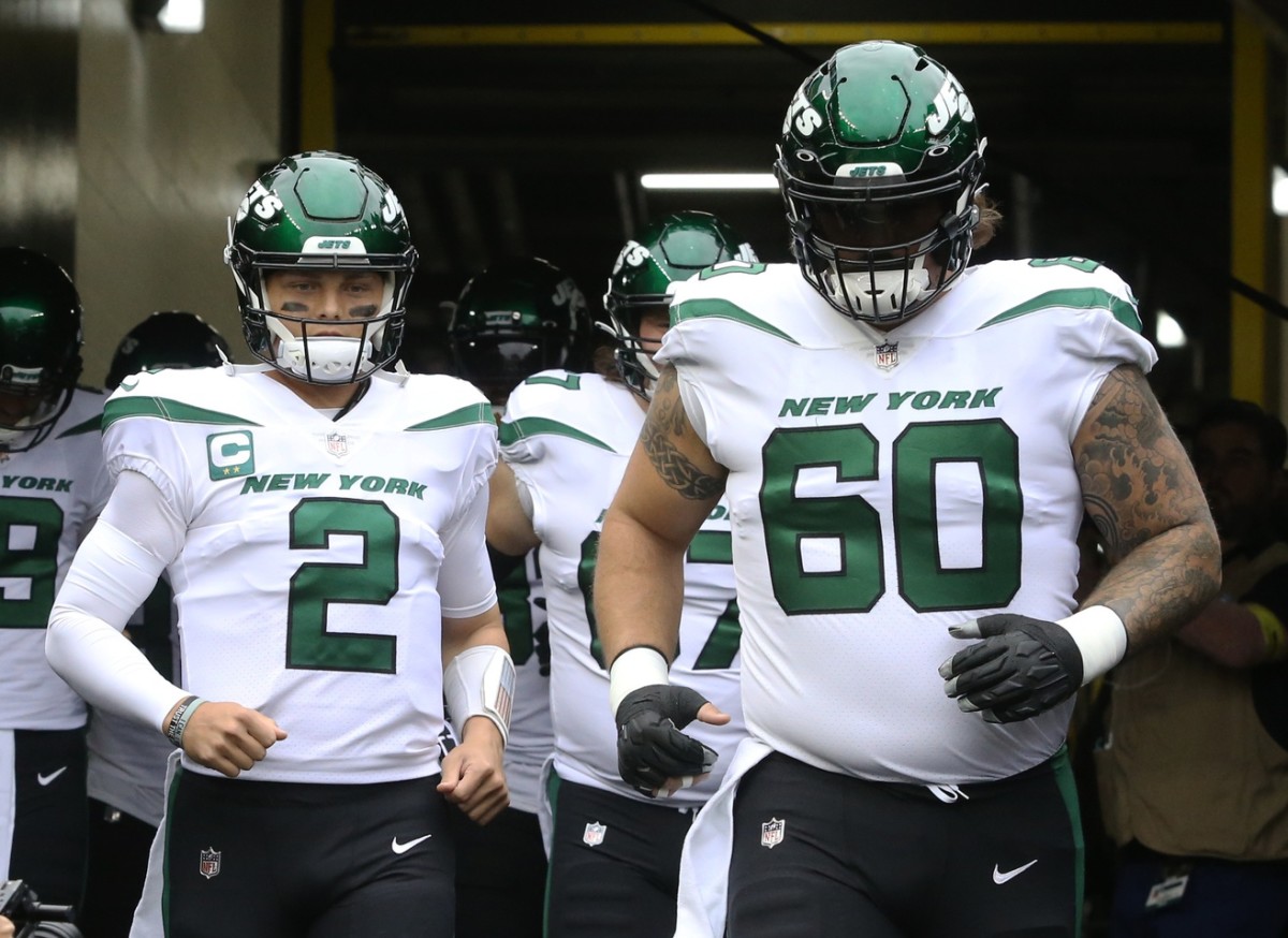 New York Jets quarterback Zach Wilson (2) and center Connor McGovern (60) take the field to warm up before the game against the Pittsburgh Steelers at Acrisure Stadium.