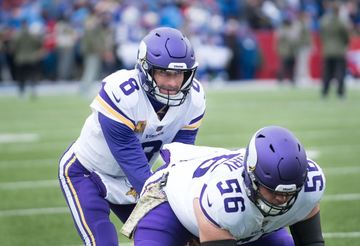 Minnesota Vikings quarterback Kirk Cousins (8) and center Garrett Bradbury (56) take practice snaps before a game against the Buffalo Bills at Highmark Stadium.