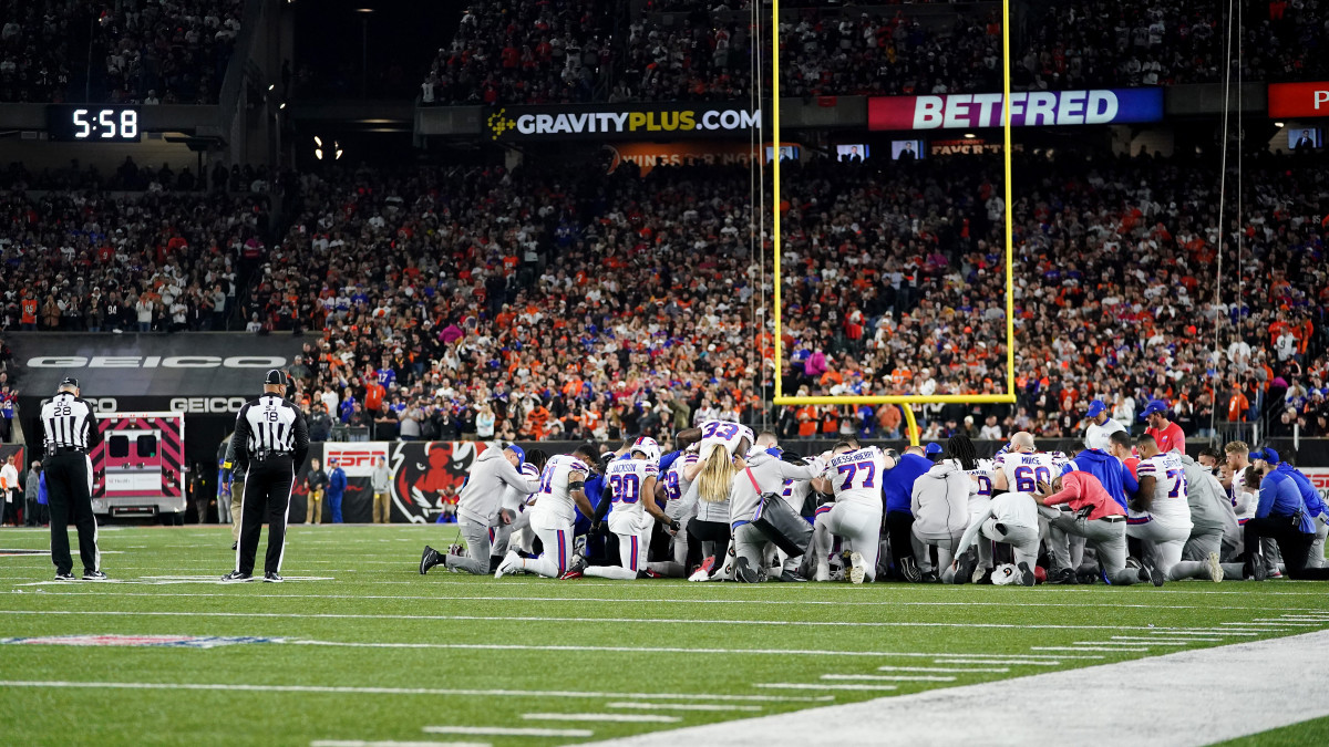 Bills players pray as Damar Hamlin is attended to by medical personnel