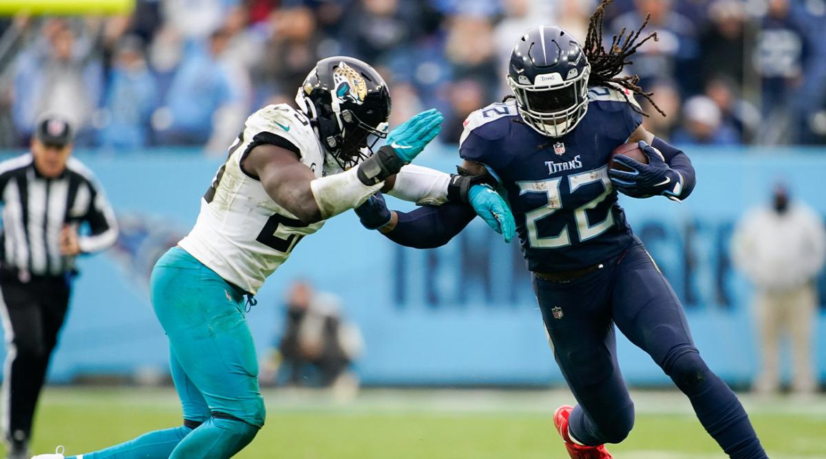 Tennessee Titans running back Derrick Henry (22) is tackled by Jacksonville Jaguars linebacker Foyesade Oluokun (23) during the fourth quarter at Nissan Stadium Sunday, Dec. 11, 2022, in Nashville, Tenn.