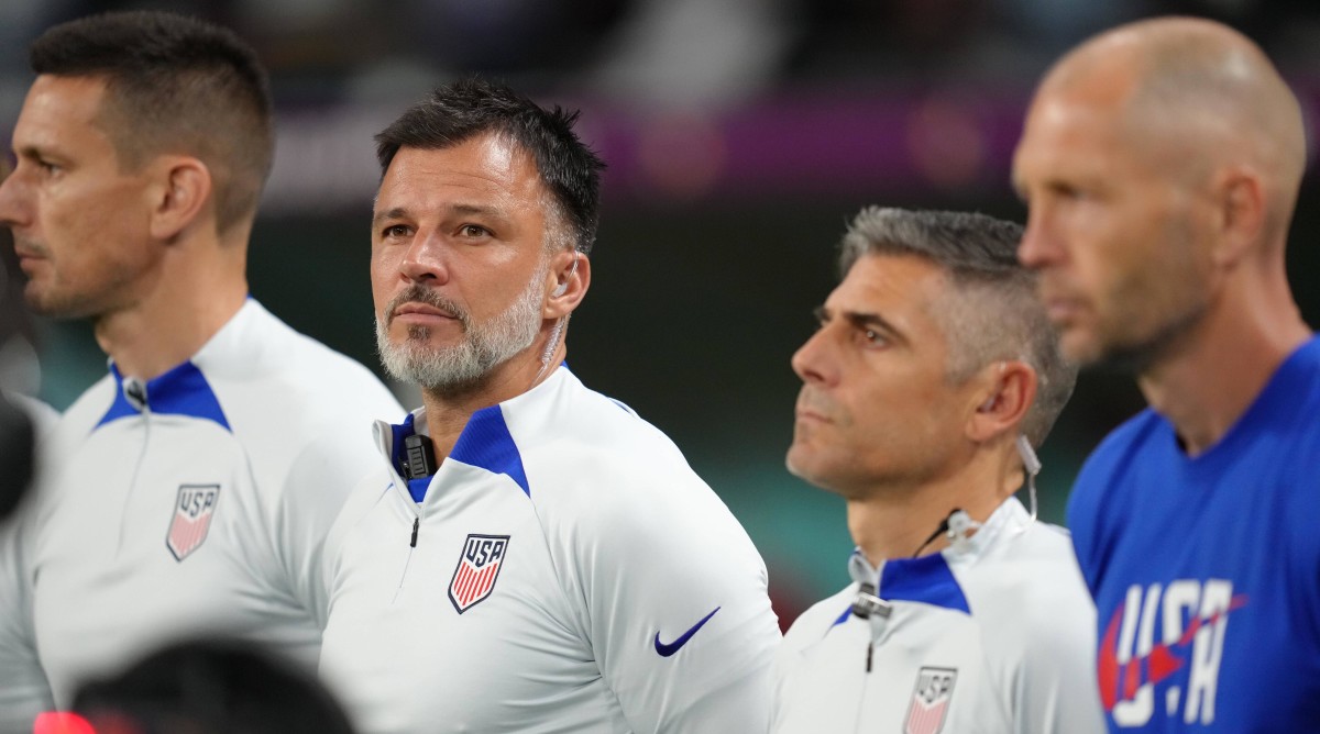 Anthony Hudson standing for the anthem before a World Cup match.
