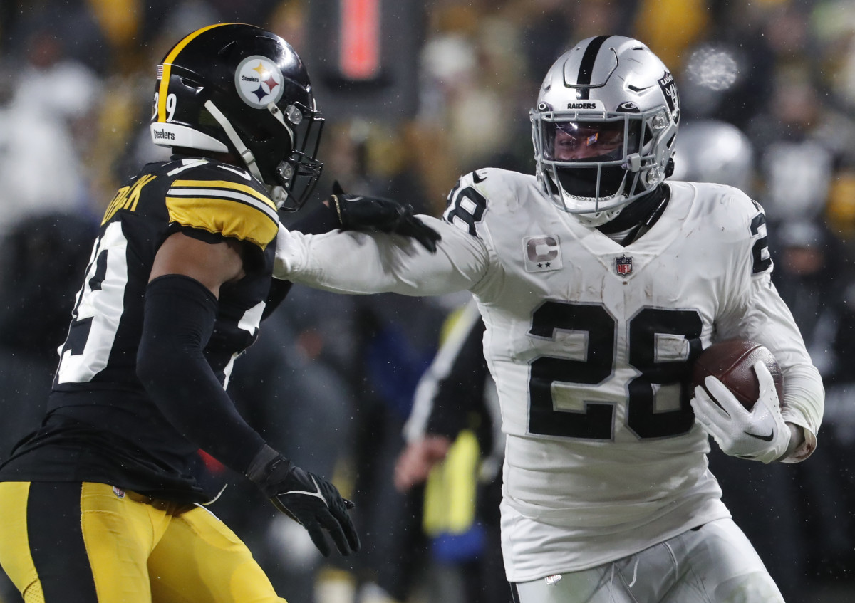Las Vegas Raiders running back Josh Jacobs (28) carries the ball against Pittsburgh Steelers safety Minkah Fitzpatrick (39) during the third quarter at Acrisure Stadium in 2022. The Steelers won 13-10.
