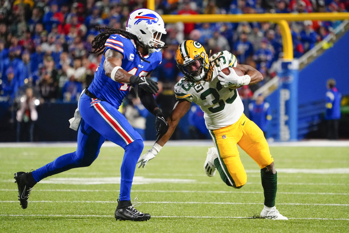Oct 30, 2022; Orchard Park, New York, USA; Green Bay Packers running back Aaron Jones (33) runs with the ball with Buffalo Bills linebacker Tremaine Edmunds (49) defending during the second half at Highmark Stadium.