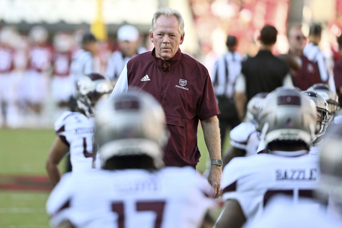 Bobby Petrino walks along the sidelines during pregame warmups with Missouri State.