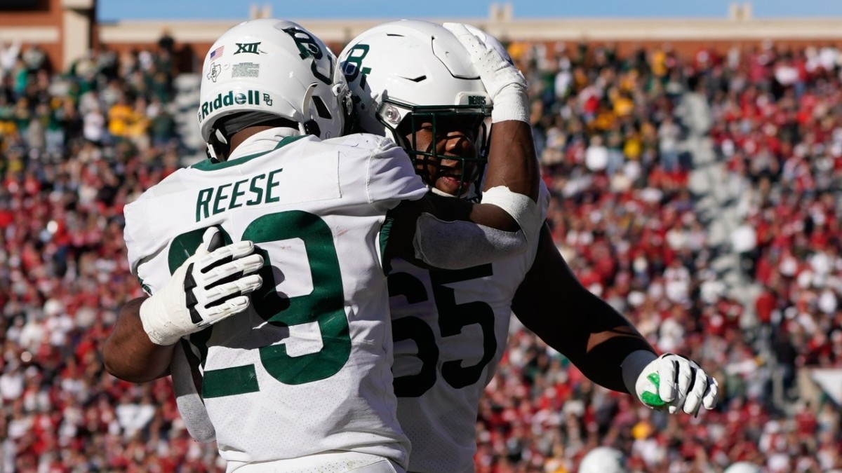 Former Baylor OL and new Florida transfer Micah Mazzccua (65) celebrates with his teammate, RB Richard Reese (29), following a rushing touchdown against the Oklahoma Sooners during the 2022 season.