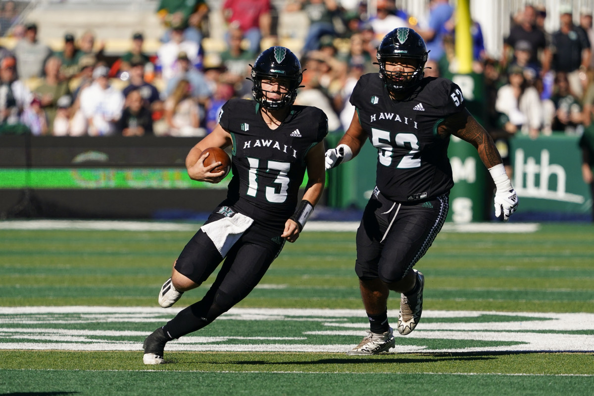 Hawaii Warriors quarterback Brayden Schager (13) runs for a gain in the first quarter at Sonny Lubick Field at Canvas Stadium.