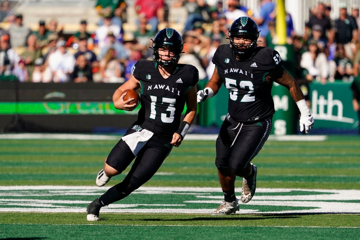 Hawaii Warriors quarterback Brayden Schager (13) runs for a gain in the first quarter at Sonny Lubick Field at Canvas Stadium.