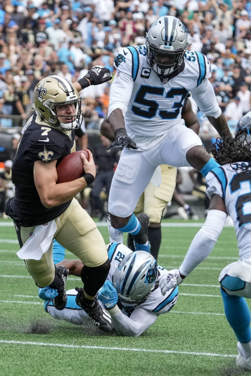 Sep 19, 2021; New Orleans Saints Taysom Hill (7) is brought down by Carolina Panthers safety Jeremy Chinn (21). Mandatory Credit: Jim Dedmon-USA TODAY