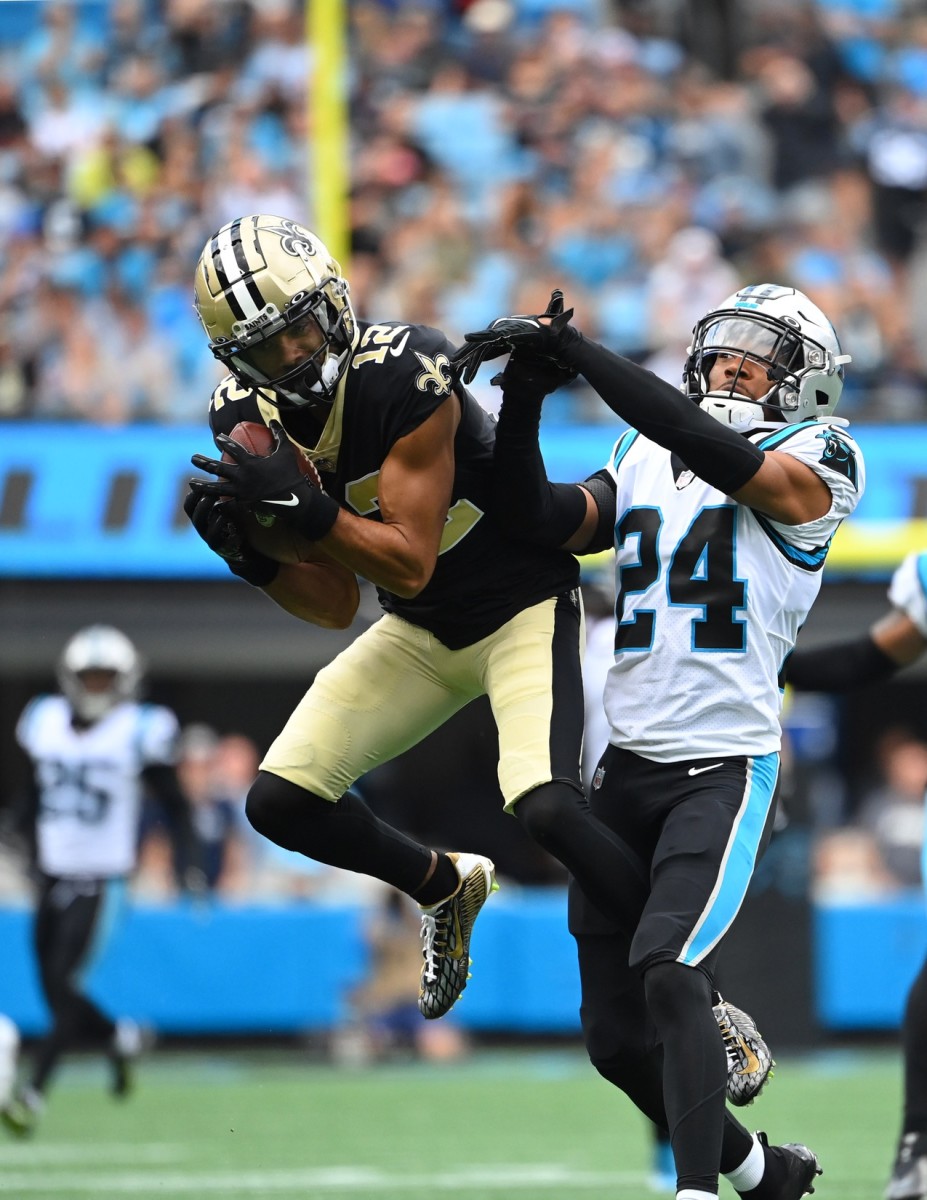 New Orleans Saints receiver Chris Olave (12) catches the ball against Carolina Panthers cornerback CJ Henderson (24). Mandatory Credit: Bob Donnan-USA TODAY