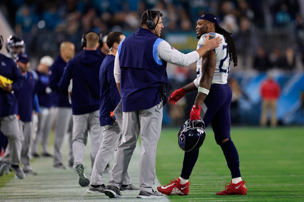 Tennessee Titans running back Derrick Henry (22) talks with head coach Mike Vrabel after coming off the field during the second quarter of an NFL football regular season matchup AFC South division title game Saturday, Jan. 7, 2023 at TIAA Bank Field in Jacksonville.