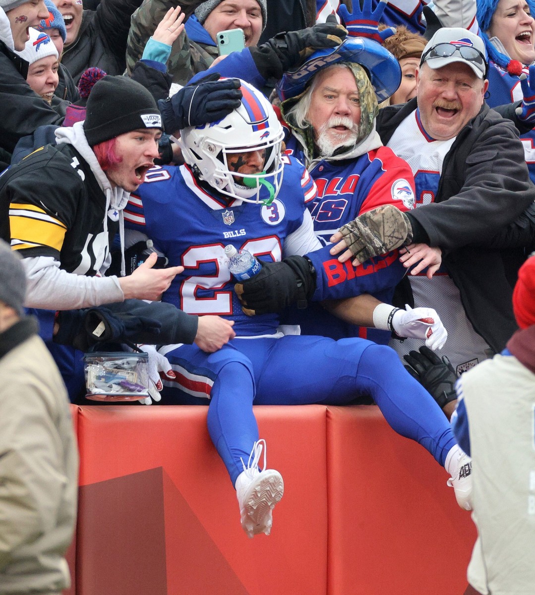 Bills kick returner Nyheim Hines celebrates with fans after scoring on the opening kickoff against the Patriots in Week 18.