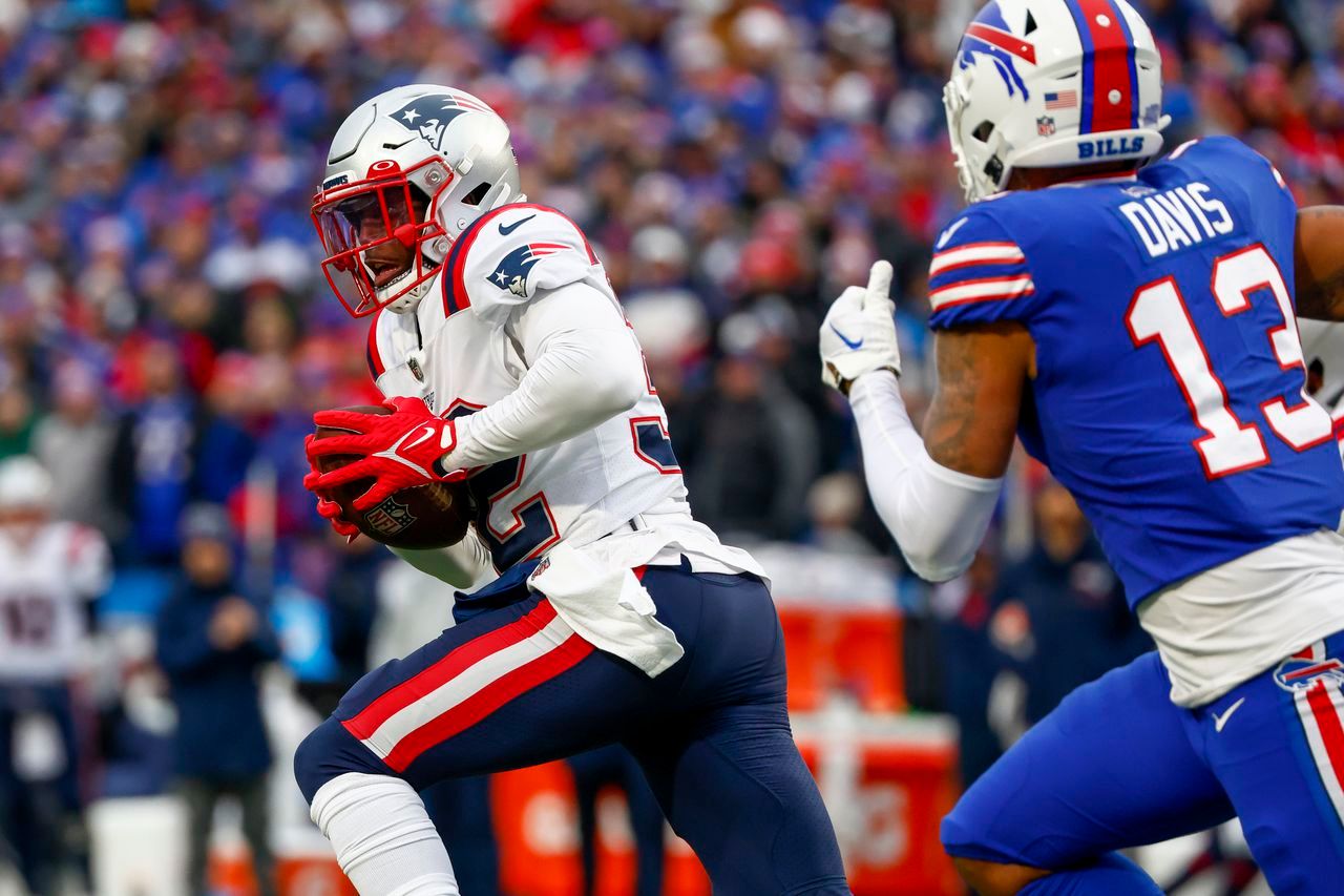 New England Patriots safety Devin McCourty (32) runs back an interception during the first half of an NFL football game against the Buffalo Bills, Sunday, Jan. 8, 2023, in Orchard Park.