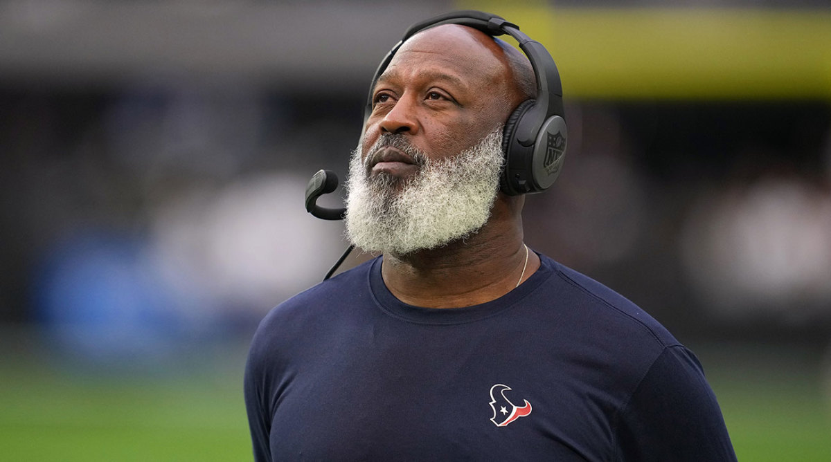 Lovie Smith looks a replay during a 2022 game.