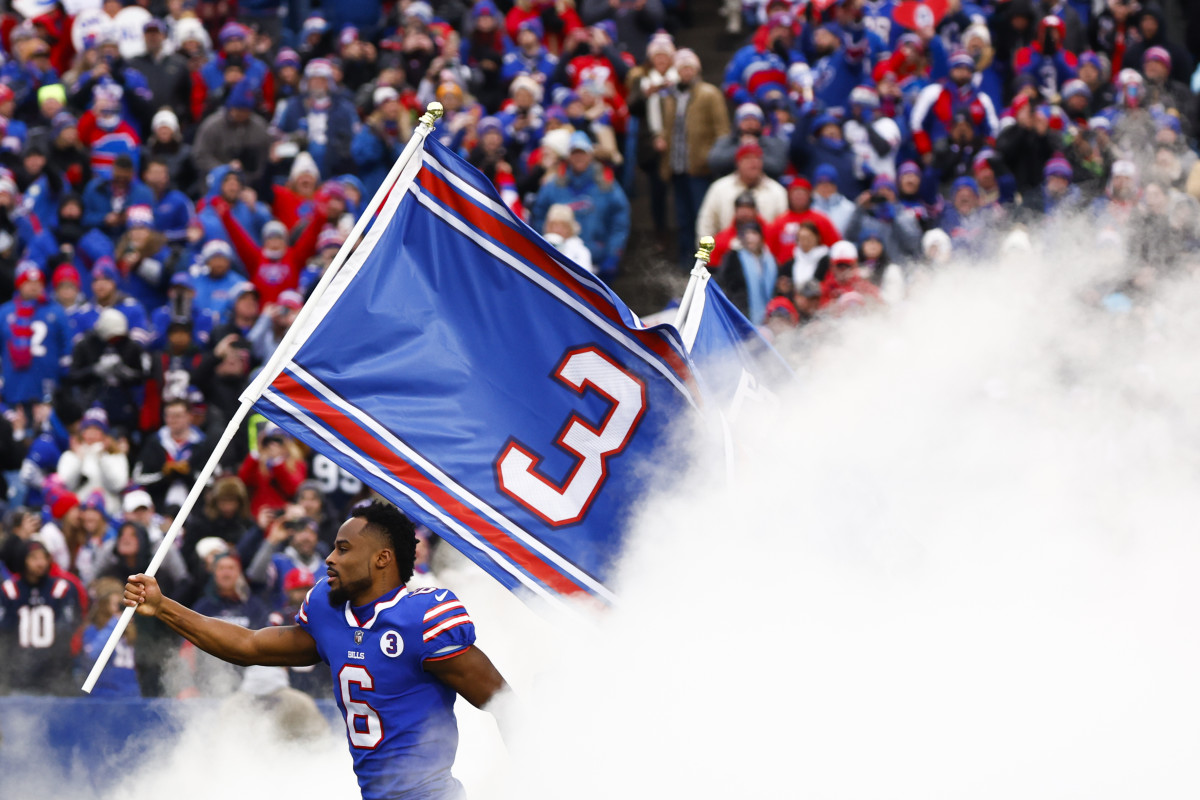 Bills players emerge from the tunnel before Patriots game with Damar Hamlin flags