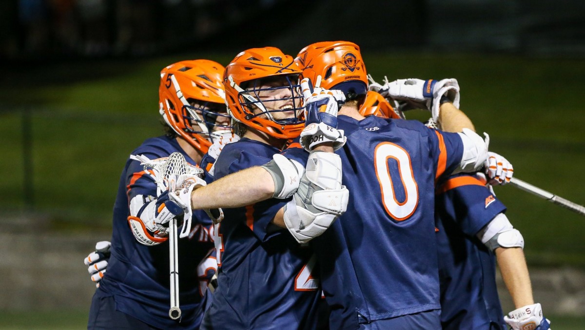 Payton Cormier celebrates with his teammates after a goal during the Virginia men's lacrosse game against Brown in the first round of the 2022 NCAA Men's Lacrosse Tournament.