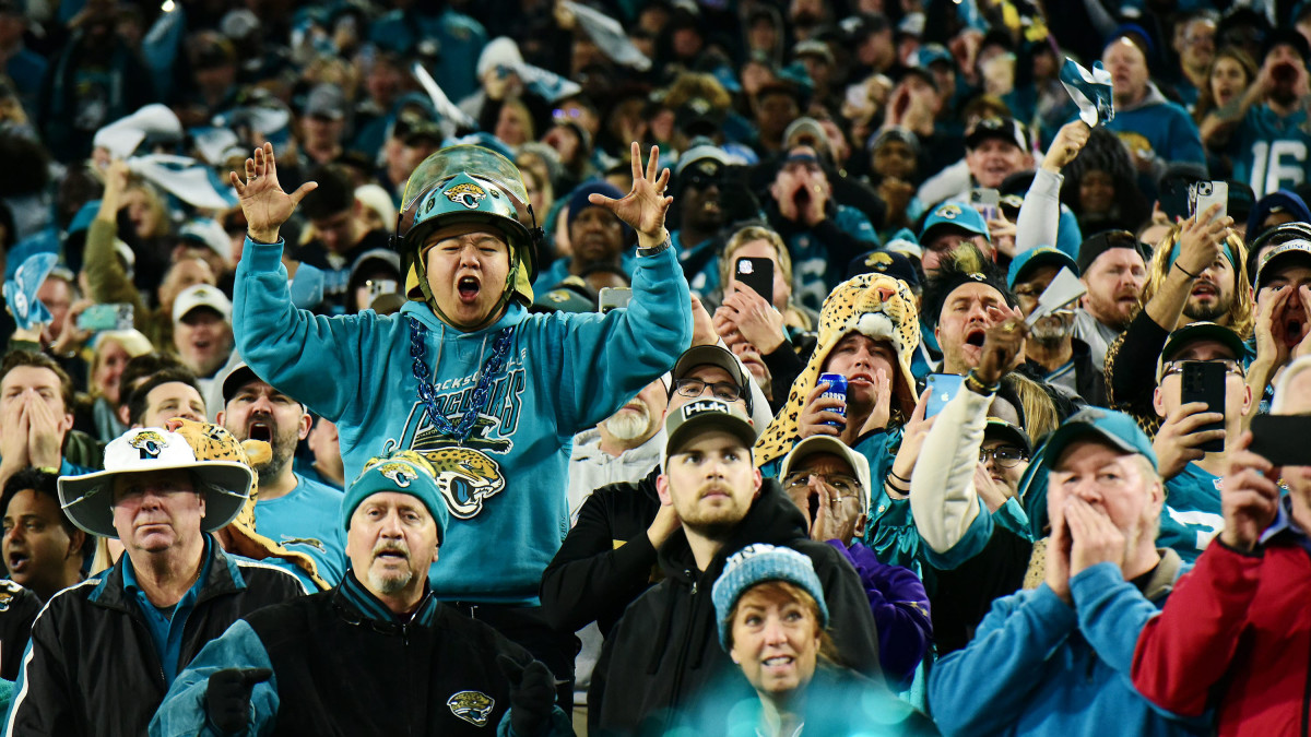 Jaguar fans celebrate the team taking the lead late in the fourth quarter against the Titans