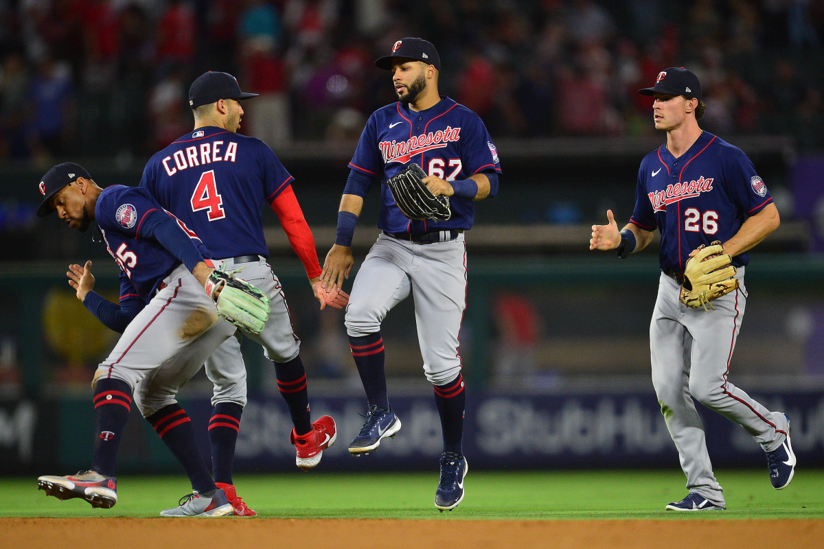 Minnesota Twins center fielder Byron Buxton, shortstop Carlos Correa, left fielder Gilberto Celestino, and right fielder Max Kepler jump on the field in celebration and high five