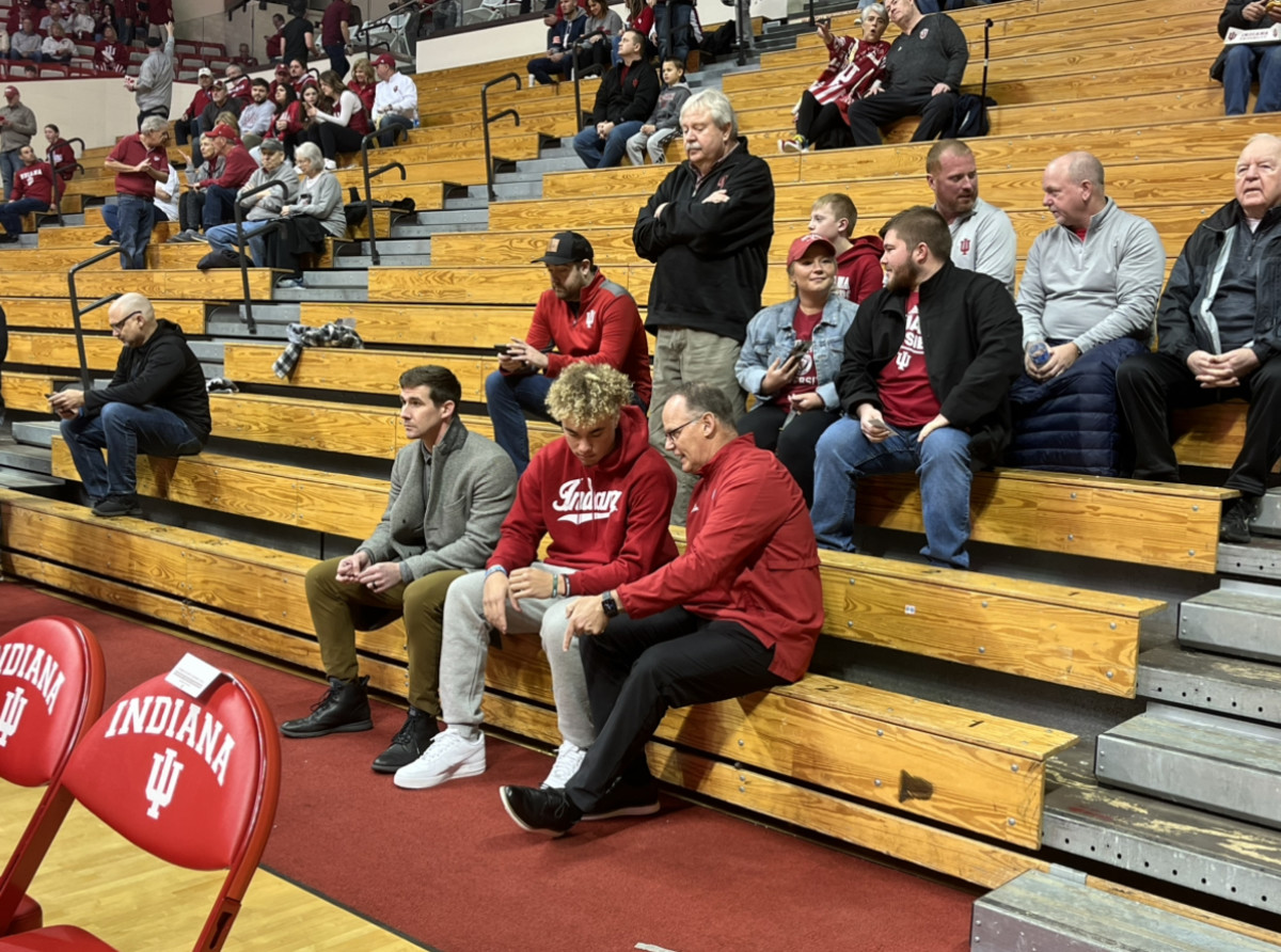 Indiana football offensive coordinator Walt Bell (left), quarterback recruit Tayven Jackson (middle) and head coach Tom Allen (right) talk before the Indiana versus Wisconsin basketball game on Saturday, Jan. 14 at Simon Skjodt Assembly Hall in Bloomington, Ind. 