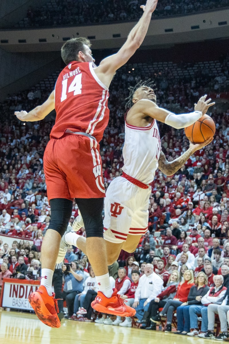 Indiana Hoosiers guard CJ Gunn (11) shoots the ball while Wisconsin Badgers forward Carter Gilmore (14) defends in the first half at Simon Skjodt Assembly Hall.