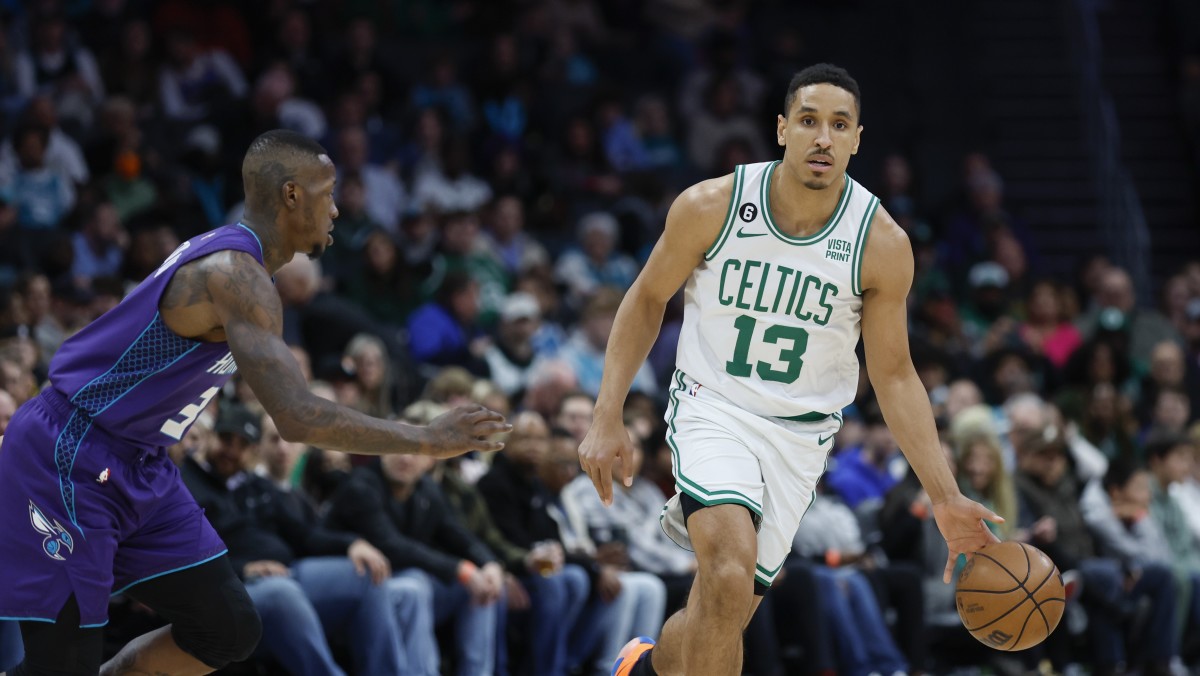 Boston Celtics guard Malcolm Brogdon (13) controls the ball against Charlotte Hornets guard Terry Rozier (3) during the first half at Spectrum Center.