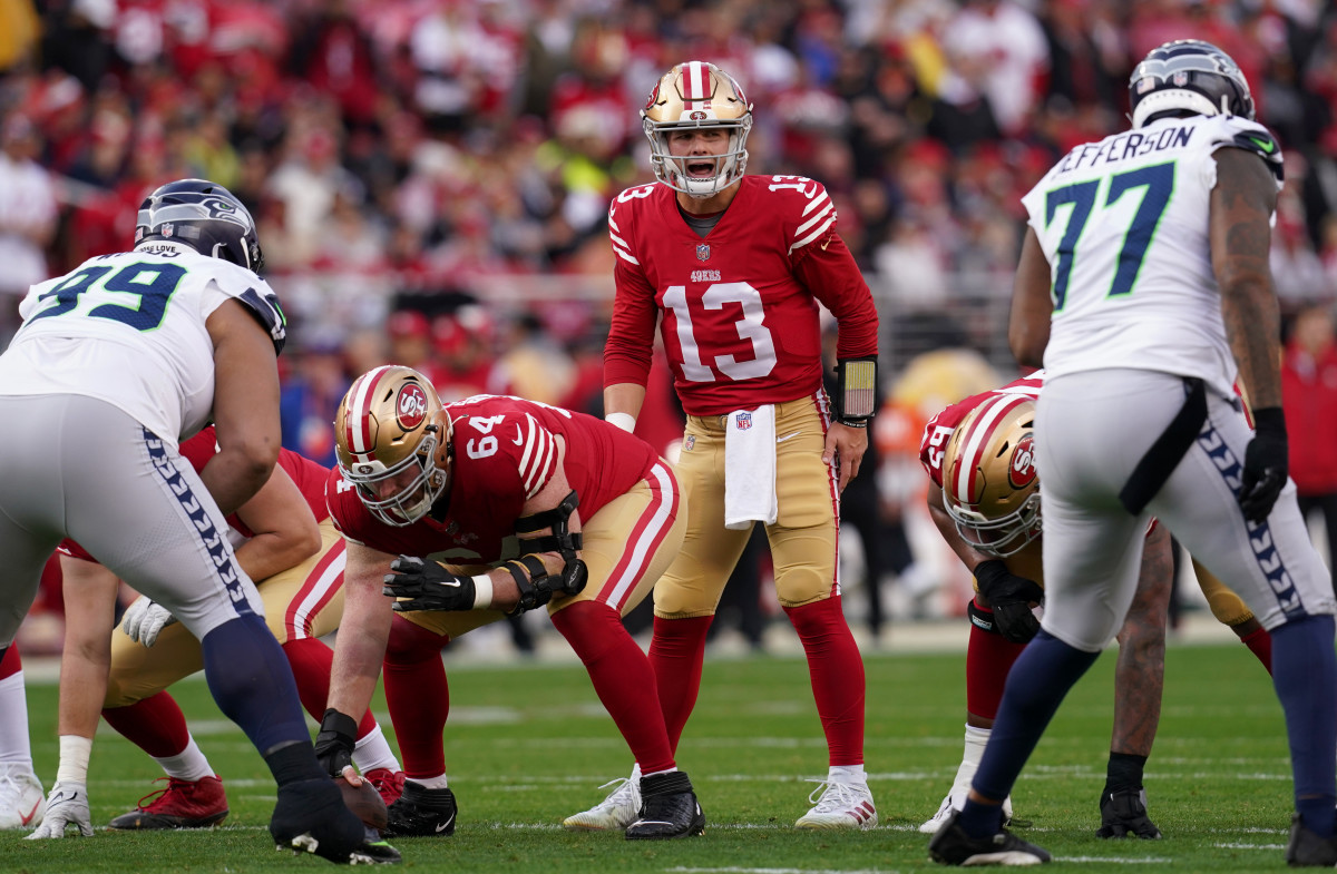 Brock Purdy calls out signals before the snap during a 49ers playoff win over the Seahawks
