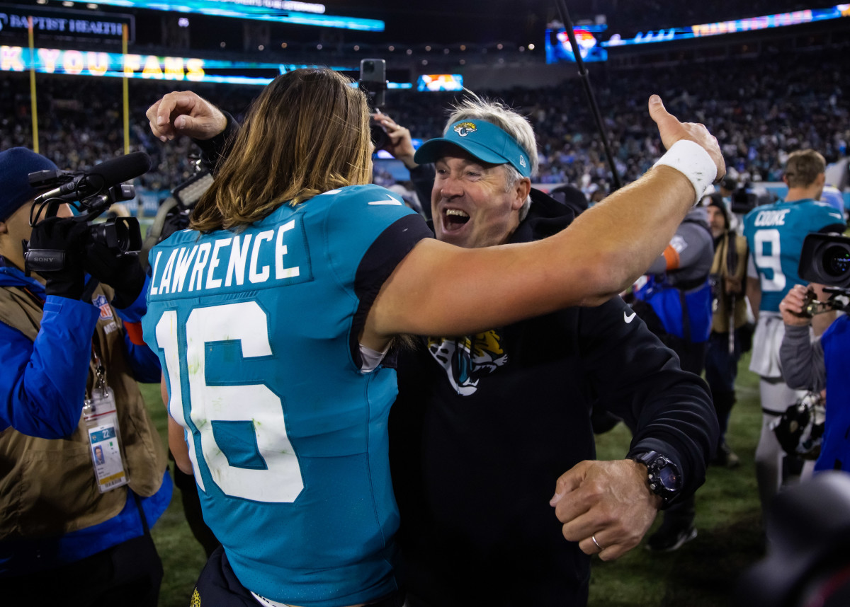 Jan 14, 2023; Jacksonville, Florida, USA; Jacksonville Jaguars quarterback Trevor Lawrence (16) celebrates with head coach Doug Pederson after defeating the Los Angeles Chargers during a wild card game at TIAA Bank Field. Mandatory Credit: Mark J. Rebilas-USA TODAY Sports