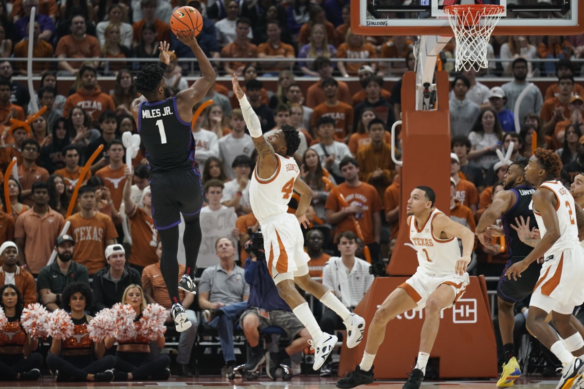 Jan 11, 2023; Austin, Texas, USA; Texas Christian Horned Frogs guard Mike Miles Jr. (1) shoots over Texas Longhorns guard Tyrese Hunter (4) during the first half at Moody Center.
