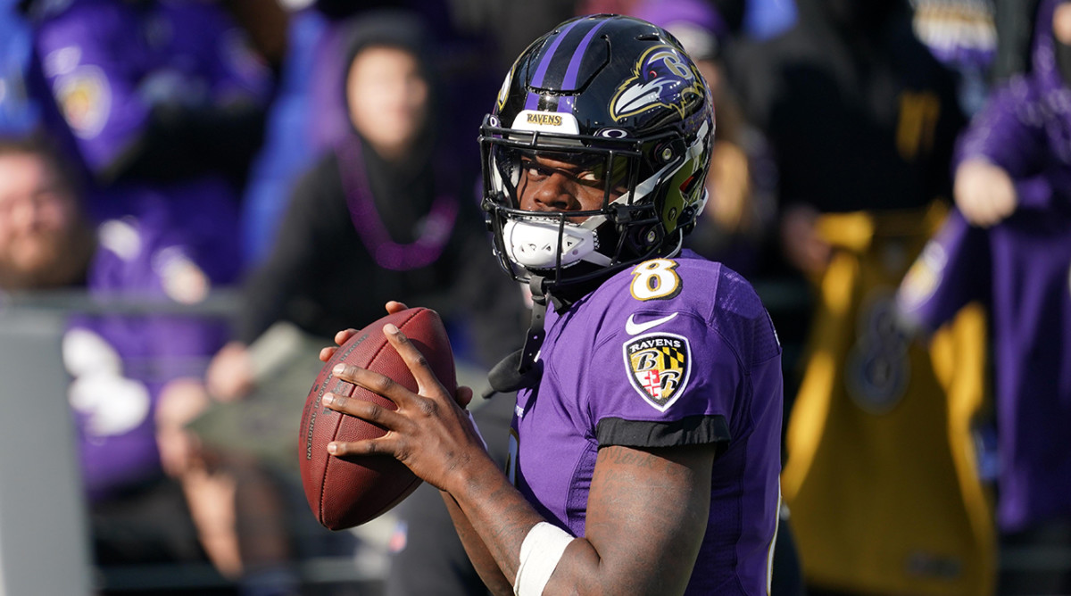 Ravens quarterback Lamar Jackson (8) warms up prior to the game against the Broncos at M&T Bank Stadium