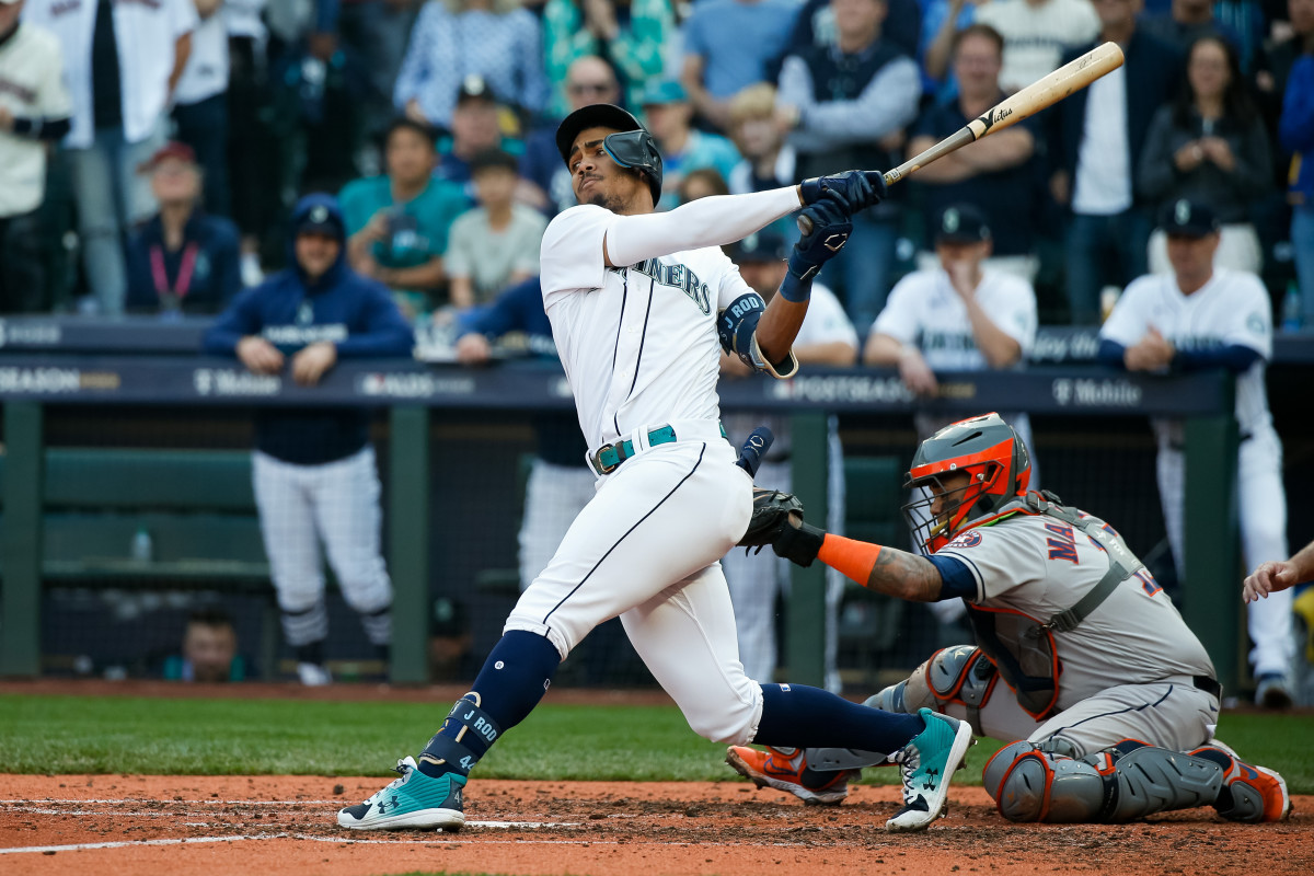 Seattle Mariners center fielder Julio Rodriguez swings with a Houston Astros catcher behind him