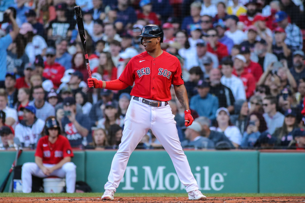 Boston Red Sox third baseman Rafael Devers holds his bat out in one hand