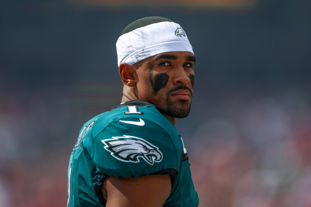 Jalen Hurts looks stoically over his shoulder while on the Eagles sideline