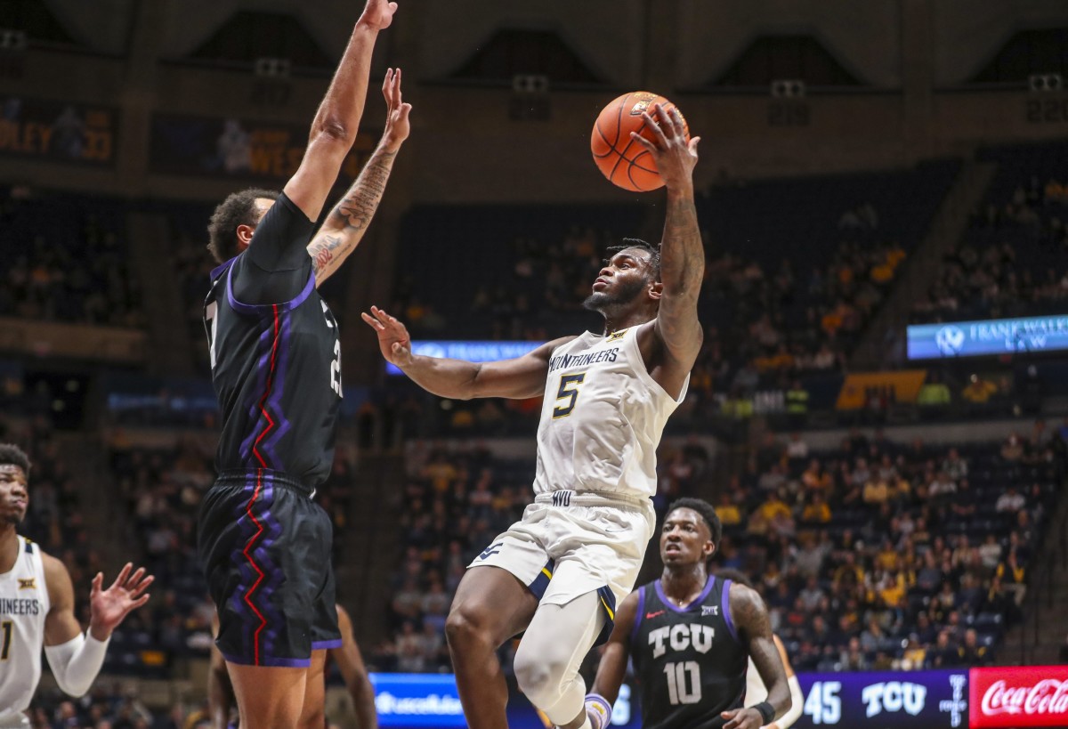 Jan 18, 2023; Morgantown, West Virginia, USA; West Virginia Mountaineers guard Joe Toussaint (5) shoots during the second half against the TCU Horned Frogs at WVU Coliseum.