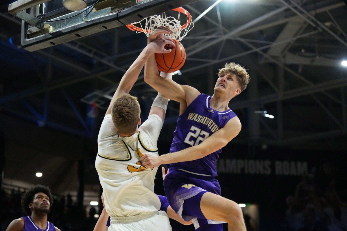 The UW's Cole Bajema fights with Colorado's Lawson Lovering for the ball.