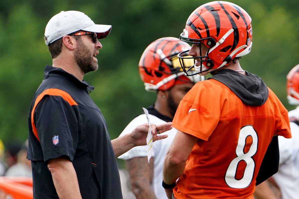 Cincinnati Bengals offensive coordinator Brian Callahan, left, talks with Cincinnati Bengals quarterback Brandon Allen (8), right, during Cincinnati Bengals training camp practice, Monday, Aug. 1, 2022, at the practice fields next to Paul Brown Stadium in Cincinnati. Cincinnati Bengals Training Camp Aug 1 0019