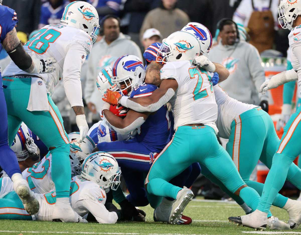 Bills running back Devin Singletary pushes the defense for for a first down near the end of the game to secure a 34-31 Buffalo win over the Dolphins.