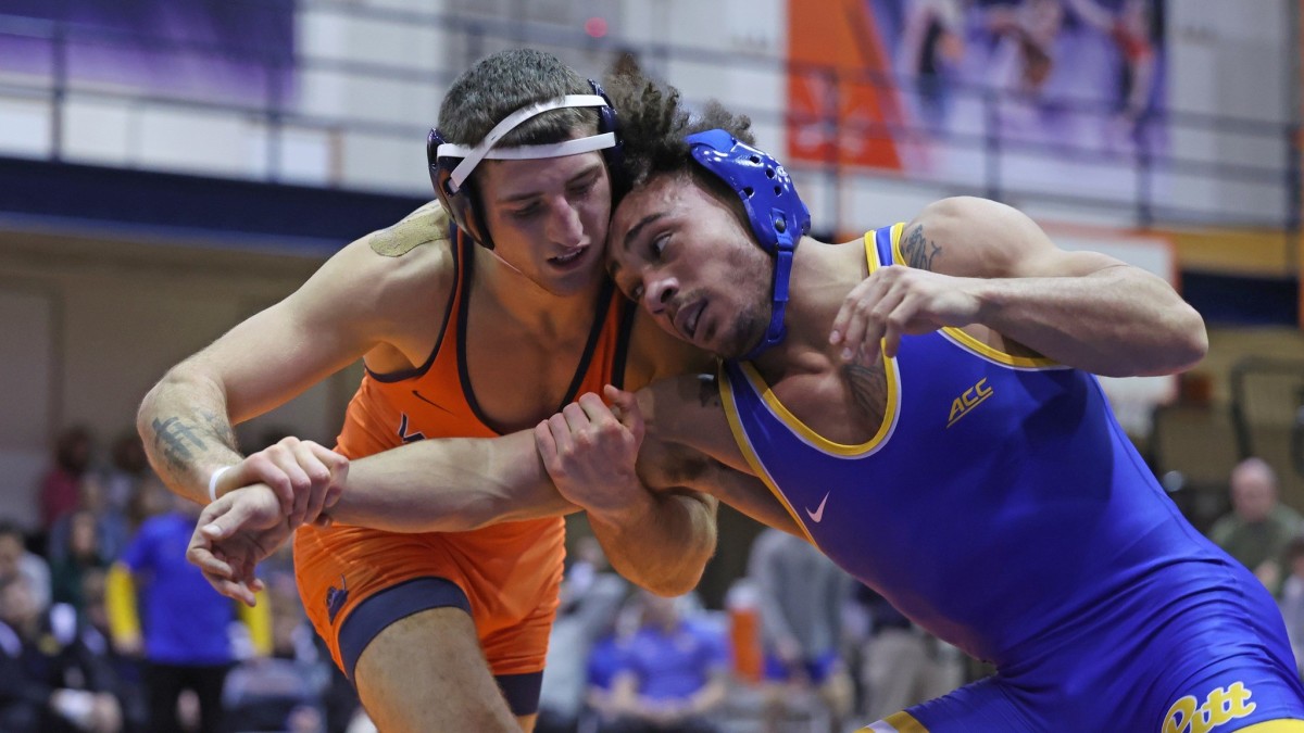 Jack Keating grappling with Dazjon Casto during the Virginia wrestling match against Pittsburgh at Memorial Gymnasium.