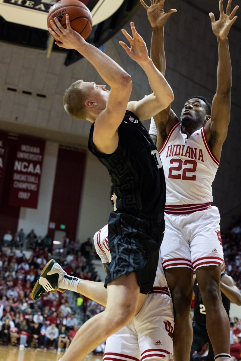 Michigan State Spartans forward Joey Hauser (10) shoots the ball while Indiana Hoosiers forward Jordan Geronimo goes up for a block.